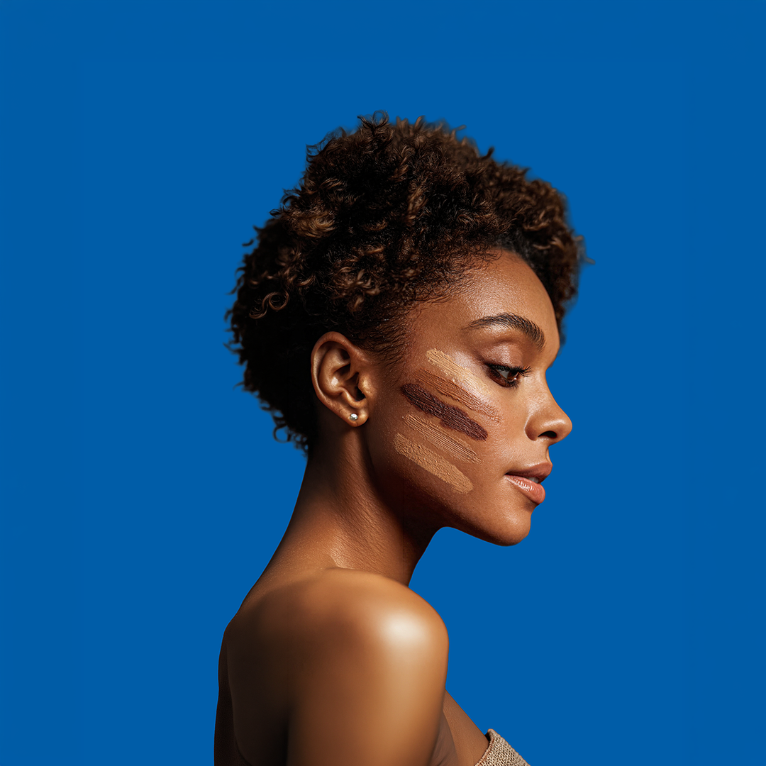 Woman with foundation swatches on cheek showcasing color matching for diverse skin tones
