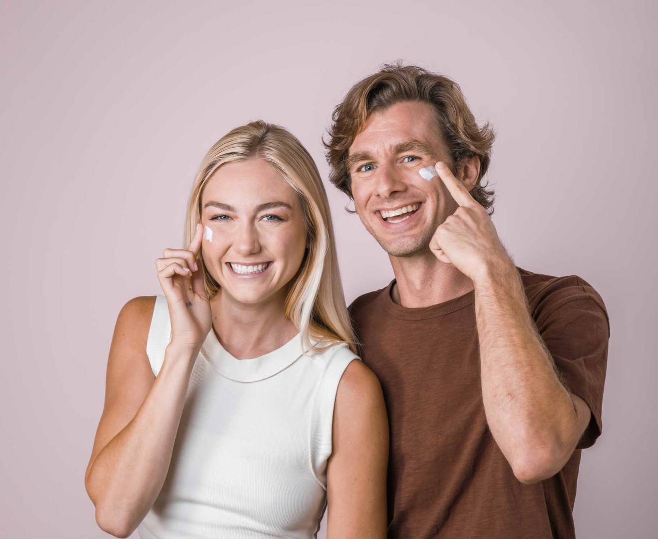 Female and male clinical testing panelists applying skincare product to their faces