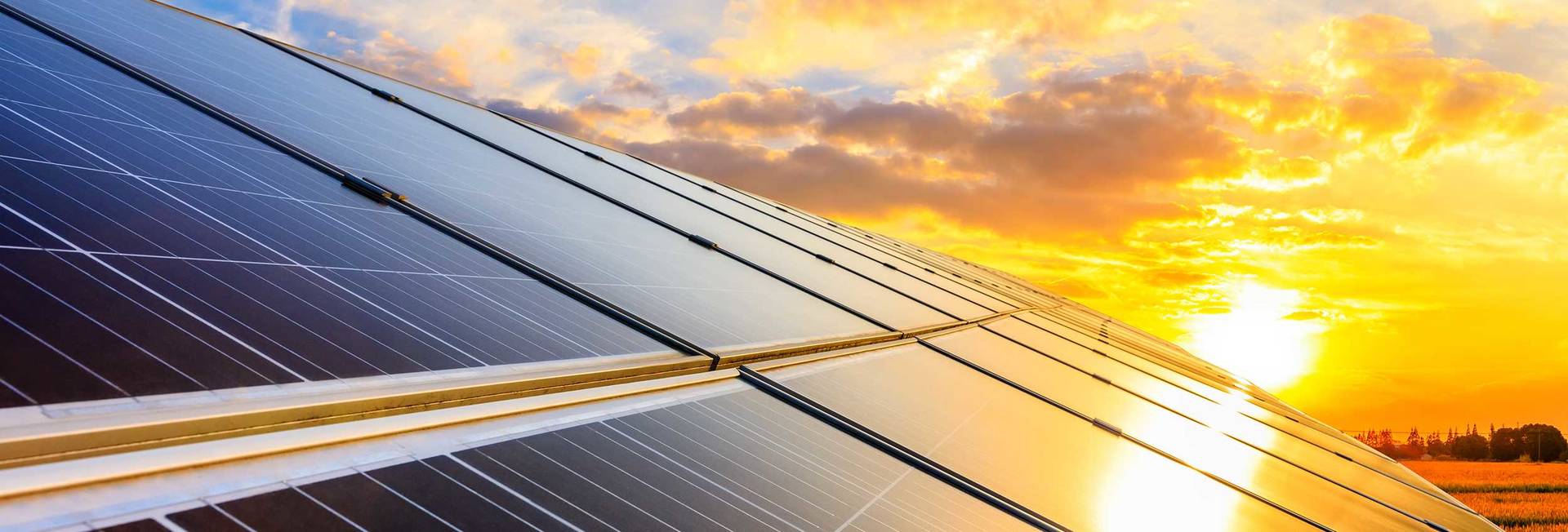 Solar panels on sunset sky background