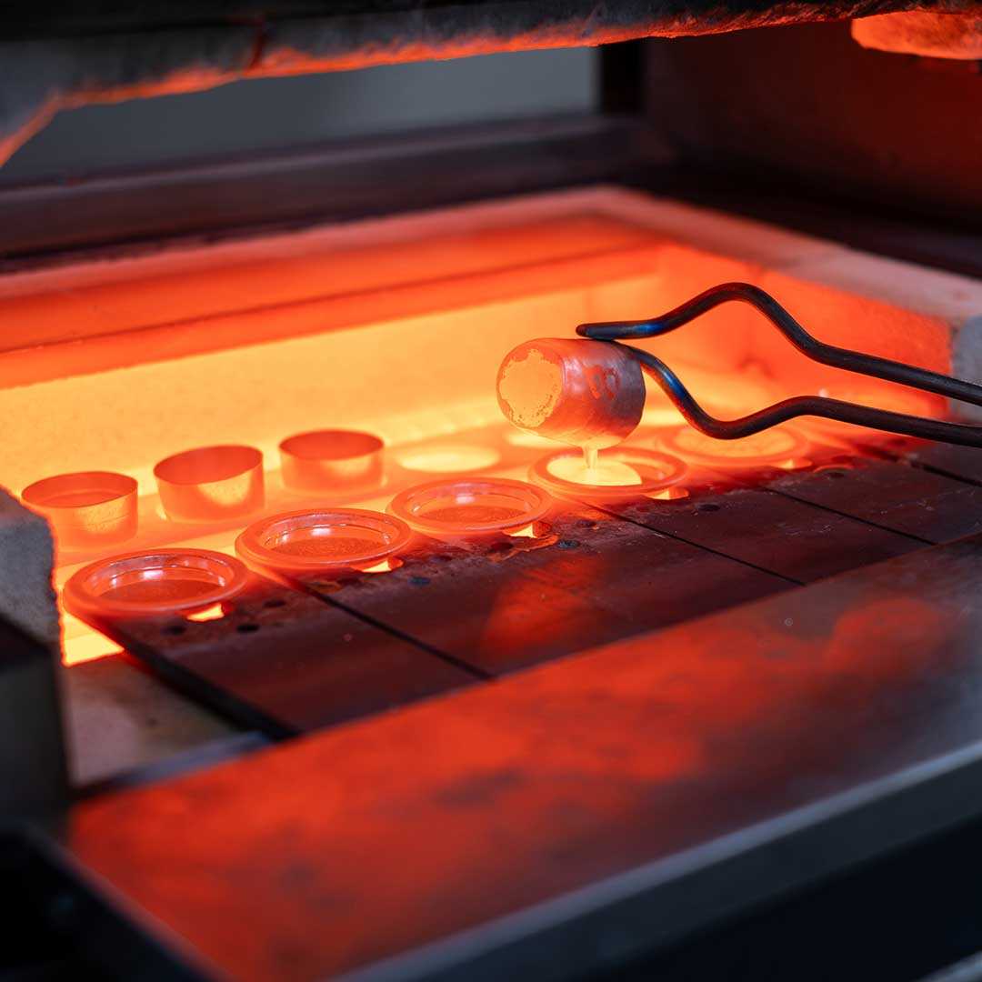 Tongs removing crucible from furnace in a Metallurgy laborator