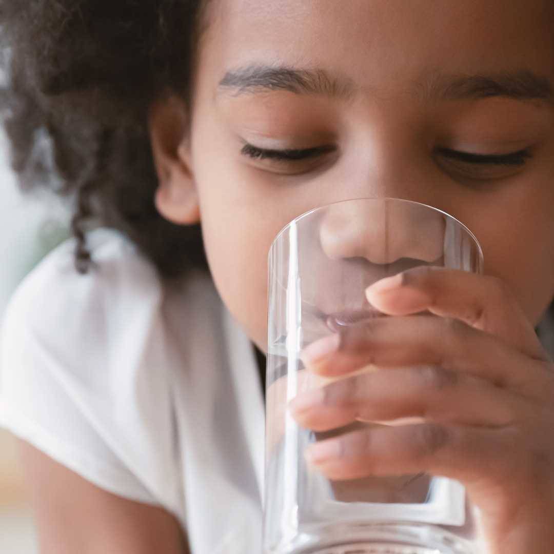 Girl drinking water from glass