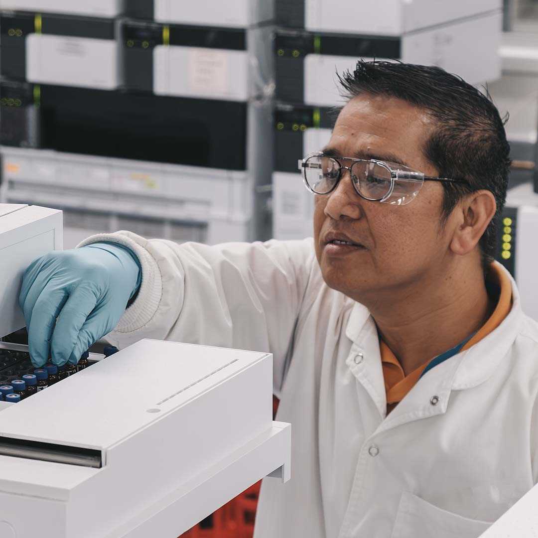 Laboratory technician uploading samples for analysis