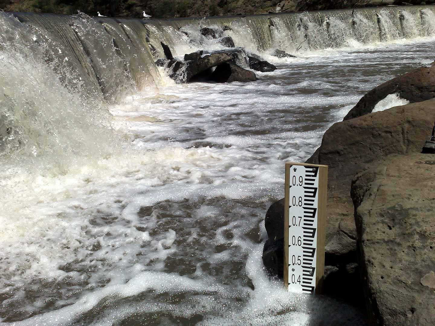 Depth scale in pool next to weir